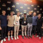 Tanner Laycock in a DigiMarCon group photo on stage
