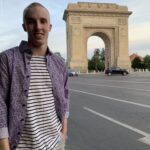 Tanner Laycock portrait in front of Arcul de Triumf in Bucharest