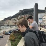 Tanner Laycock at Monaco harbor with yachts and the hillside city behind him